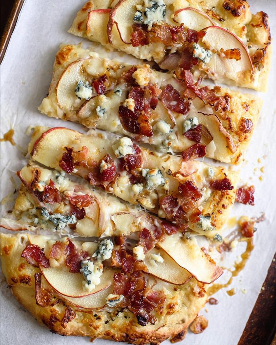 A slice of apple and bacon pizza with blue cheese, part of 10-Ingredient Pizza Night Recipes.