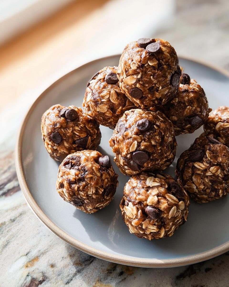 A pile of chocolate chip energy balls on a plate, perfect for breakfast ideas.