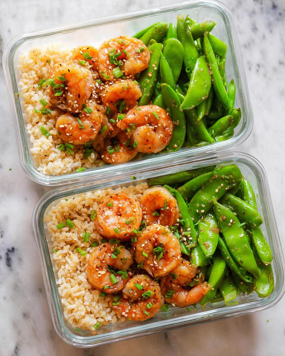 Two glass meal prep containers filled with brown rice, glazed shrimp, and snow peas, perfect for shrimp recipes meal prep.