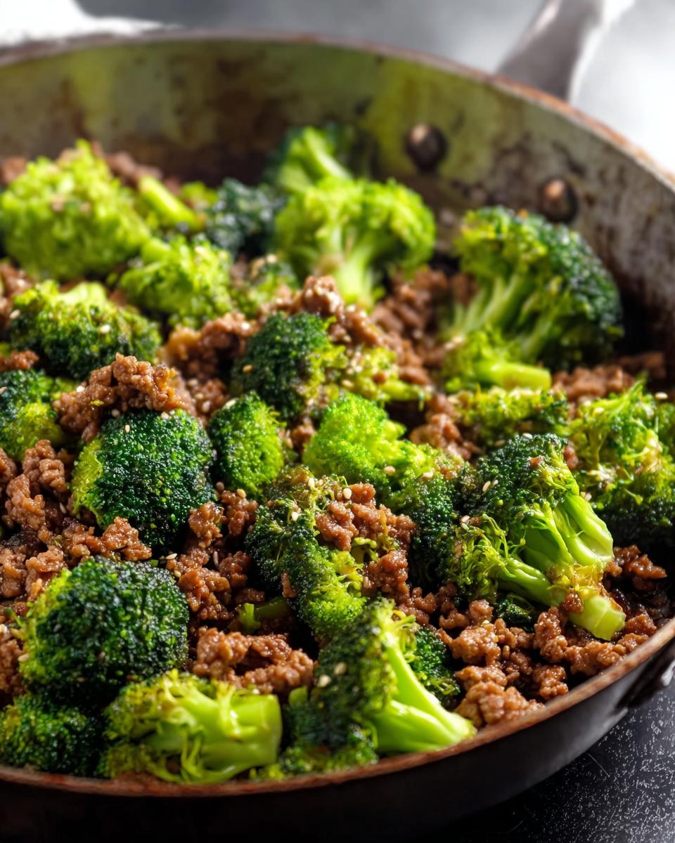 Close-up of a Keto Hamburger Broccoli Skillet, featuring seasoned ground beef mixed with vibrant green broccoli florets, sprinkled with sesame seeds.