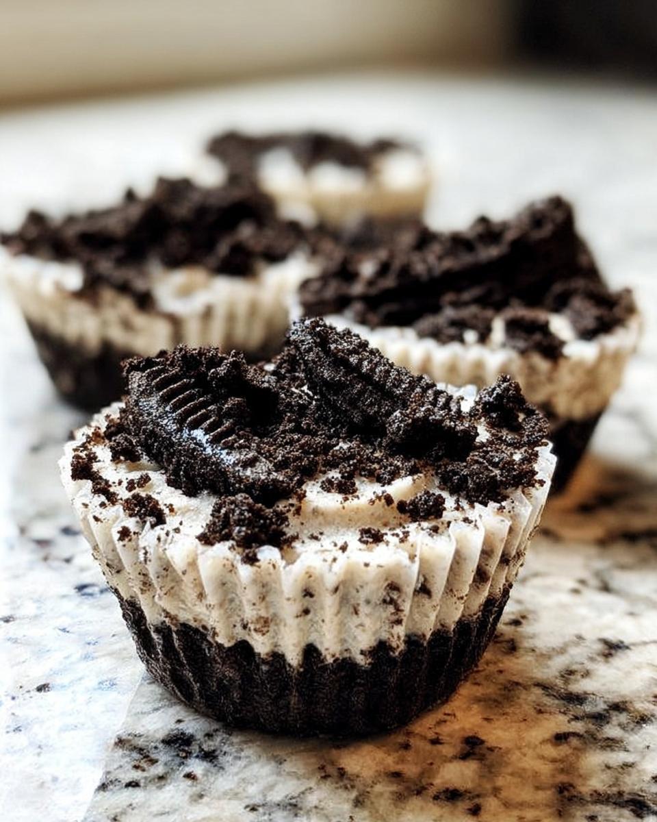 Close-up of a Healthy No-Bake Oreo Cheesecake Bite topped with crushed Oreos and a cookie piece.