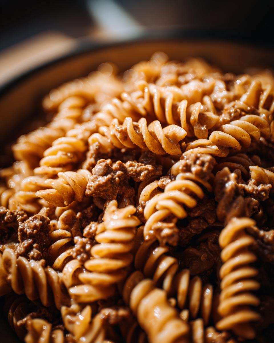 Close-up of spiral pasta coated in a rich, creamy beef sauce, showcasing the texture of the Creamy High Protein Beef Pasta.