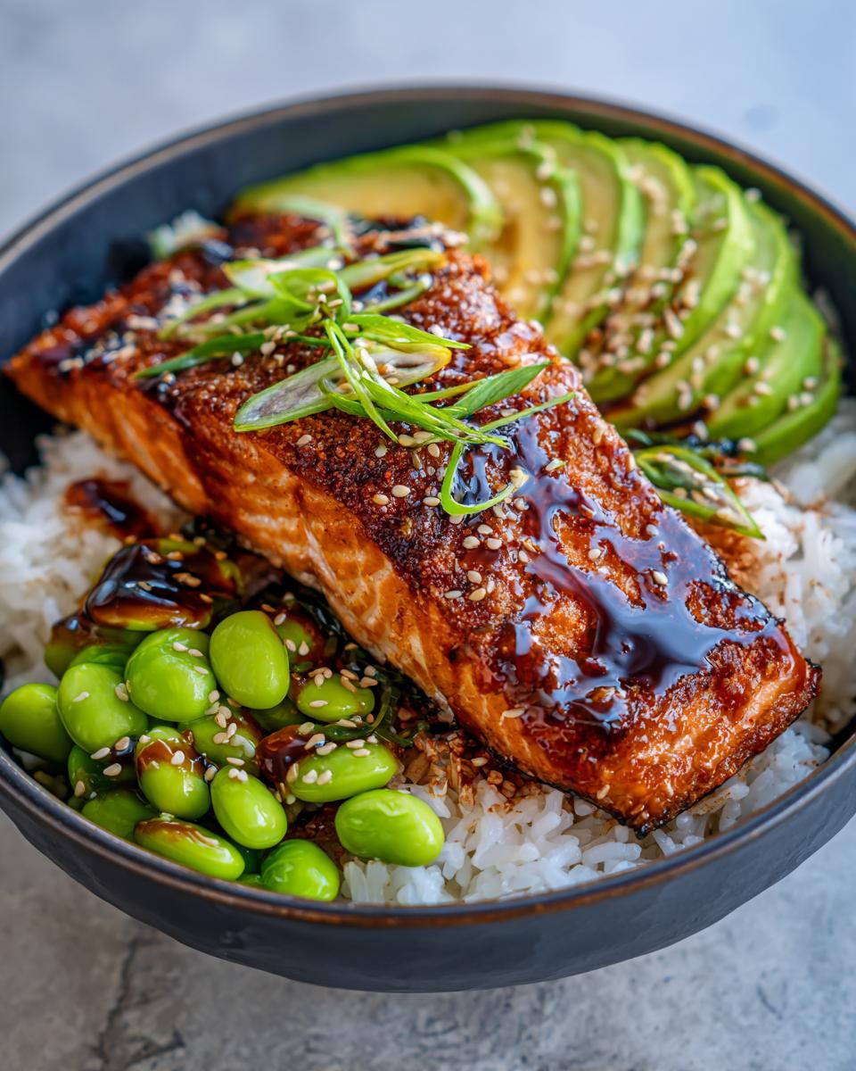 Close-up of a delicious Crispy Salmon and Rice Bowl with avocado slices and edamame.